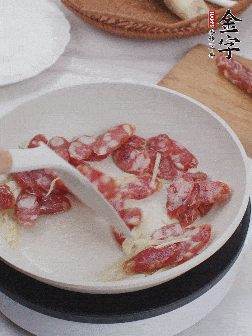 油溫3成熱時，下姜絲、蒜片、香腸炒出油脂。