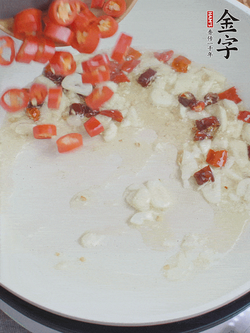 油6成熱，下蒜末、干紅辣椒煸炒，出香味后再放美人椒、香腸。